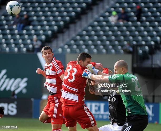 Goal keeper Ivan Turina of AIK punches the ball away from Blas Perez of FC Dallas and Kenny Cooper of FC Dallas during the first half of the game at...