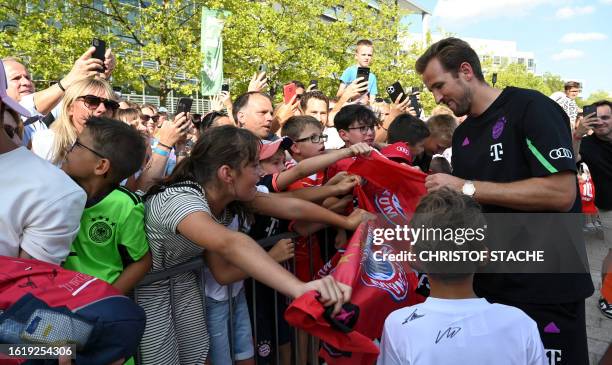 Bayern Munich's English forward Harry Kane signs autographs and poses for photos with fans at a sponsoring event at the German car manufacturer Audi...