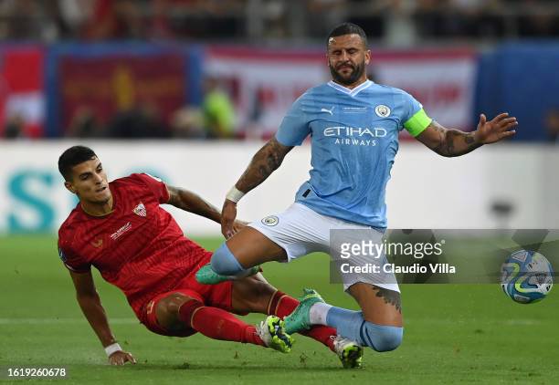 Kyle Walker of Manchester City is challenged by Erik Lamela of Sevilla during the UEFA Super Cup 2023 match between Manchester City FC and Sevilla FC...