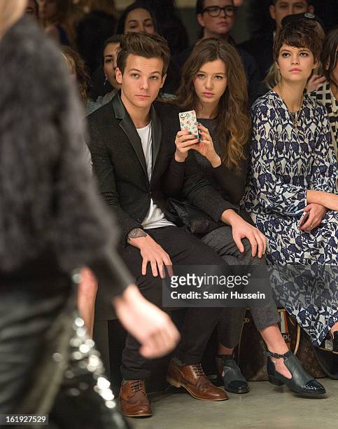 Louis Tomlinson from One Direction, Eleanor Calder and Pixie Geldof attend the Topshop Unique show at the Tate Modern during London Fashion Week...