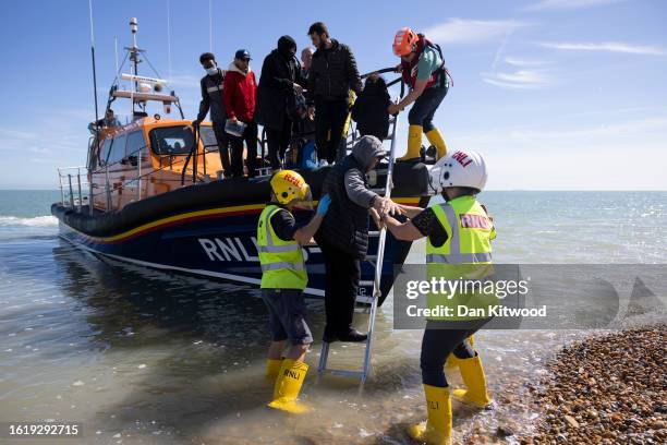 Families are helped ashore by the RNLI after being rescued in the English Channel by the RNLI on August 16, 2023 in Dungeness, England. Over 100,000...