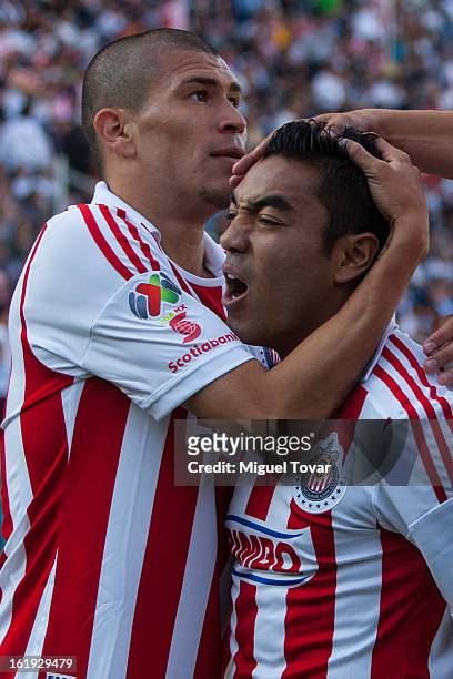 Marco Fabian of Chivas celebrates after scoring with Jorge Enriquez during a match between Puebla and Chivas as part of the Clausura 2013 at...