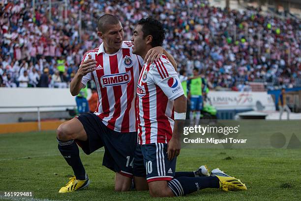 Marco Fabian of Chivas celebrates after scoring with Jorge Enriquez during a match between Puebla and Chivas as part of the Clausura 2013 at...