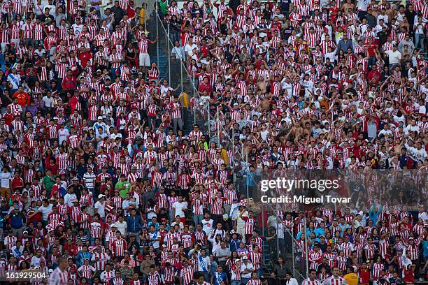 Supporters of Chivas cheer for their team during a match between Puebla and Chivas as part of the Clausura 2013 at Cuauhtemoc Stadium on February 17,...