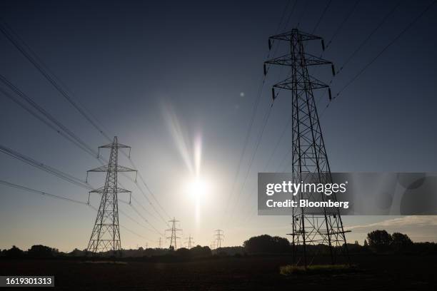 Electricity pylons near Sudbury, UK, on Wednesday, Aug. 23, 2023. The energy price cap level, set by regulator Ofgem, is expected to ease slightly...