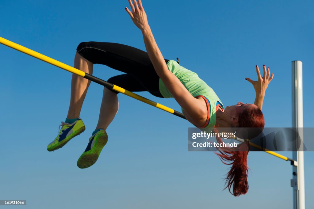 Young woman at high jump