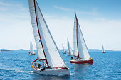 Large number of sailboats racing at regatta