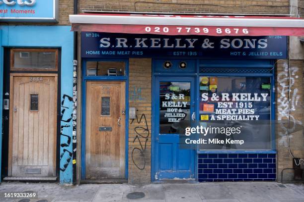 Street scene in the East End business along Bethnal Green Road where many small businesses and independent shops supply the area including this meat...