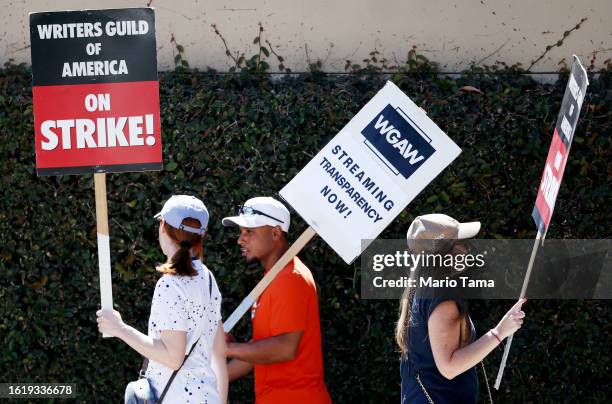 Striking WGA members picket outside Warner Bros. Studio on August 16, 2023 in Burbank, California. The Writers Guild of America reportedly met with...