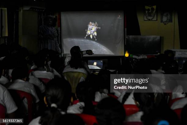 School children's watch the live telecast of the soft landing process of Chandrayaan 3 on the surface of South pole of moon , as seen at a school in...