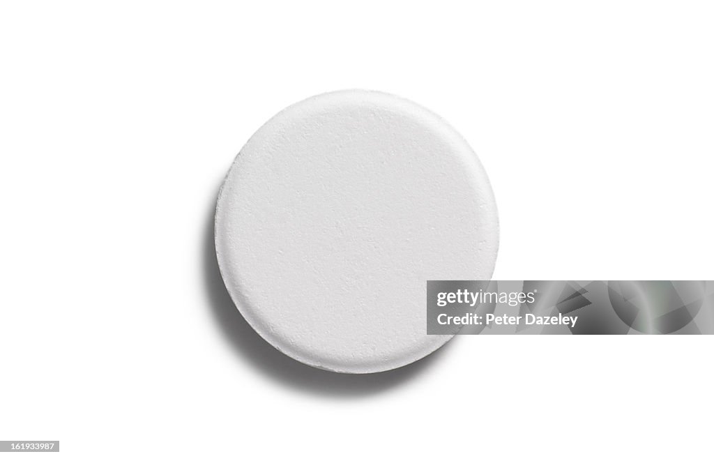 Single aspirin pill close up