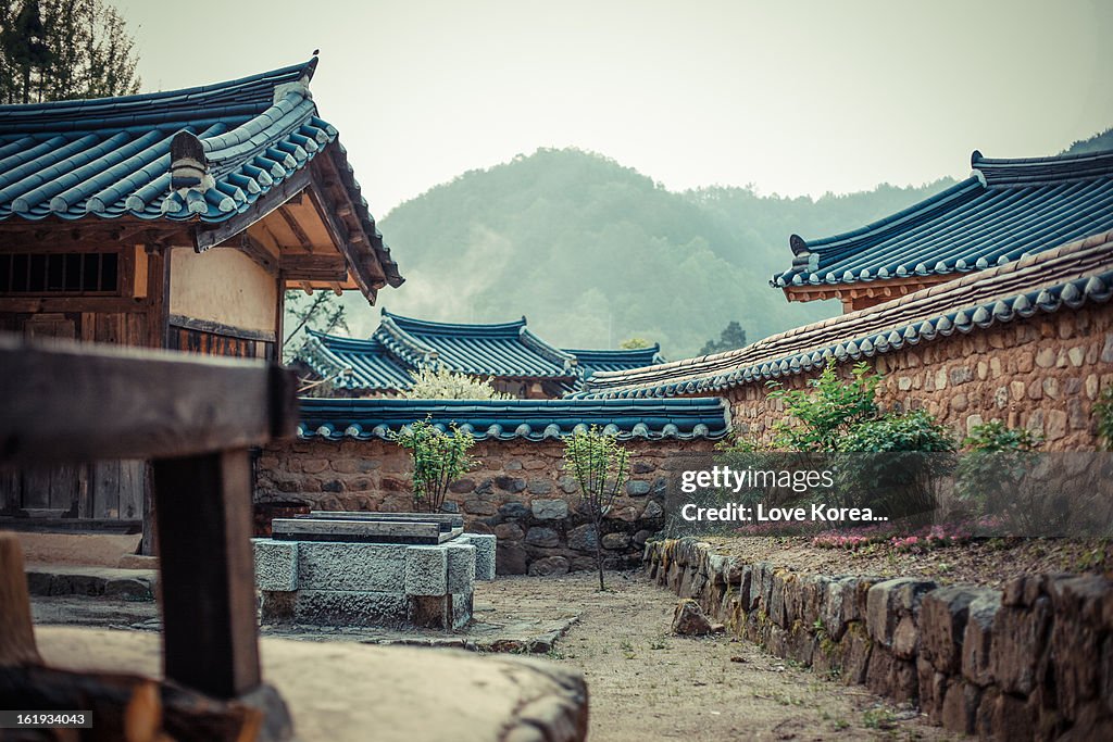 Early morning view in the courtyard of a traditional koream wood house, a hanok. Old village full of hanok's in the area of Cheongsong with typical Korean stone walls.