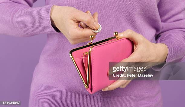 woman with coin and purse - rosa handtasche stock-fotos und bilder