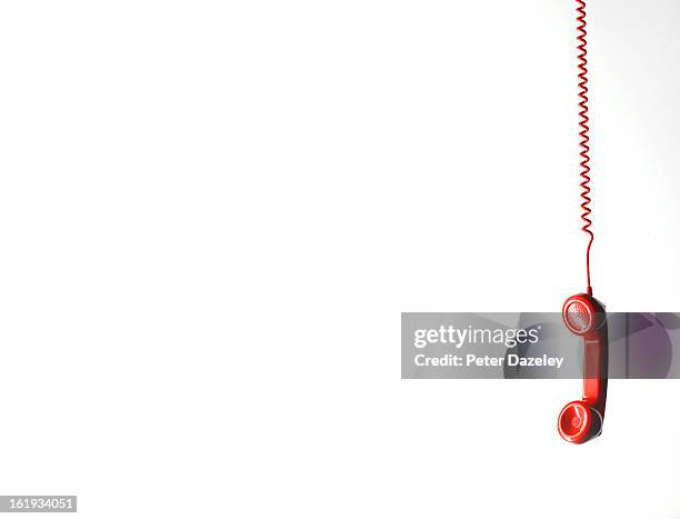 hanging red phone with copy space - telefoondraad stockfoto's en -beelden