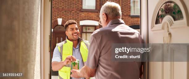 pharmacy delivery to senior man - home delivery stock pictures, royalty-free photos & images