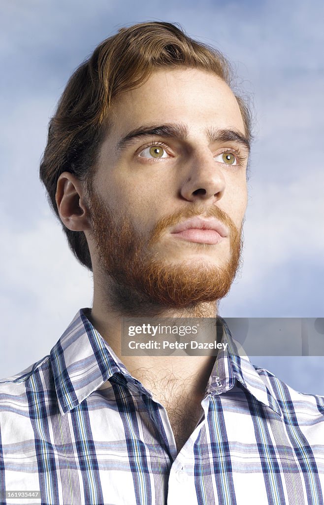 Man with beard looking into sky
