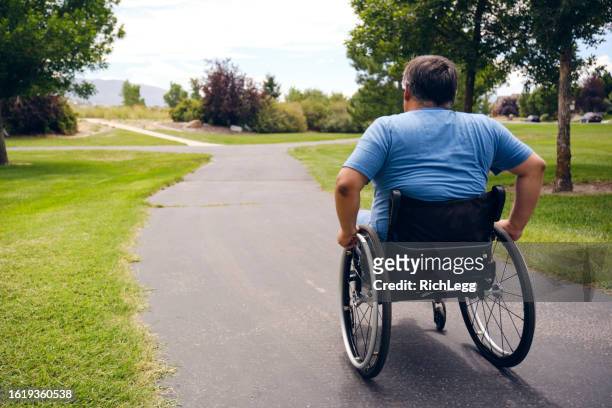 disabled man in a park - disability rights stock pictures, royalty-free photos & images