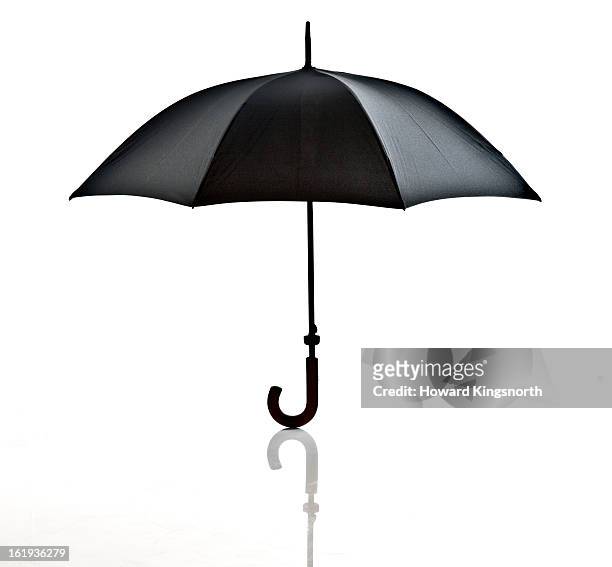 black umbrella on white background - umbrella stock pictures, royalty-free photos & images