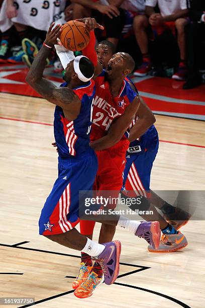 Kobe Bryant of the Los Angeles Lakers and the Western Conference blocks the shot of LeBron James of the Miami Heat and the Eastern Conference during...