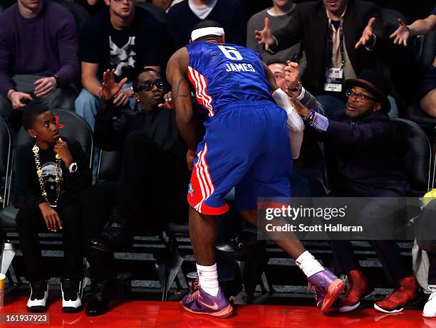 LeBron James of the Miami Heat and the Eastern Conference falls into the front row that includes Sean "Diddy" Combs and Spike Lee during the 2013 NBA...