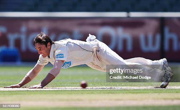 Bowler Will Sheridan of the Bushrangers falls on the pitch after bowling during day one of the Sheffield Shield match between the Victorian...