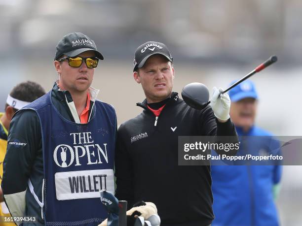 Danny Willett of England discusses his drive with his caddie during the second round of the 144th Open Championship at the Old Course at St Andrews...