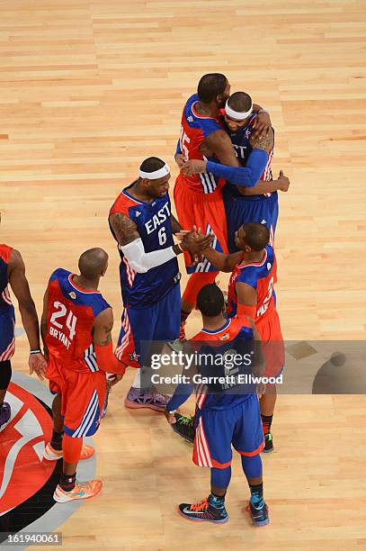 Carmelo Anthony, LeBron James and Kyrie Irving of the Eastern Conference All-Stars shake hands with Kevin Durant, Chris Paul and Kobe Bryant of the...