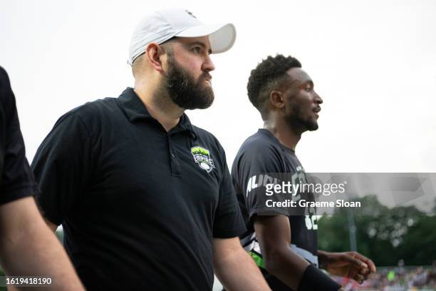Coach Charlie Hoppes and player Marques Brownlee of the New York Empire leave the field during the AUDL East Division Championship game against the...