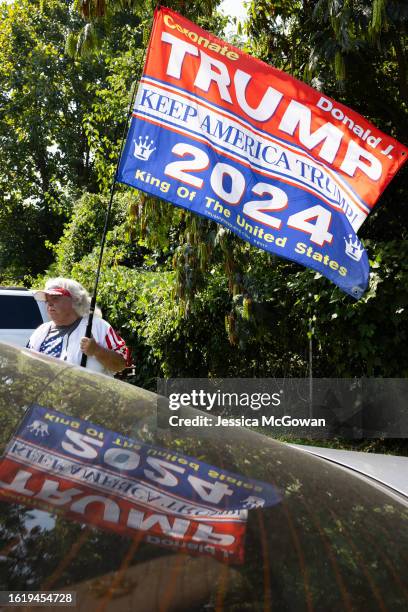 Trump supporter Sharon Anderson waves a flag outside of the Fulton County Jail entrance on August 23, 2023 in Atlanta, Georgia. Defendants in the...