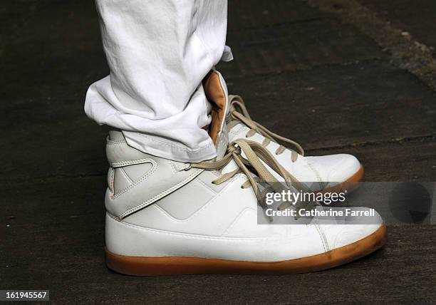 Victor Philpott, blogger, wearing white leather boots by MMM X H & M, and white trousers from Massimmo Dutti at London Fashion Week Fall/Winter...