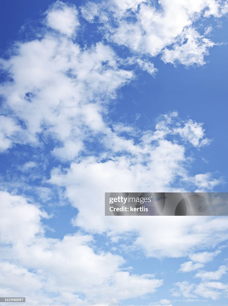 Dark blue sky with lots of white clouds