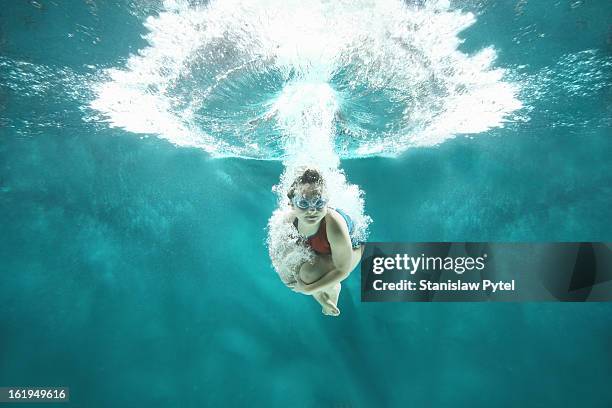 small girl jumping into the water- underwater view - children swimming stock-fotos und bilder