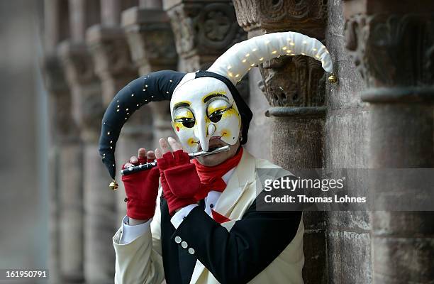 Performes wearing the "Ueli" costume playes a piccolo after the traditionell "Morgestraich" of the Basel Fasnacht Carnival on February 18, 2013 in...