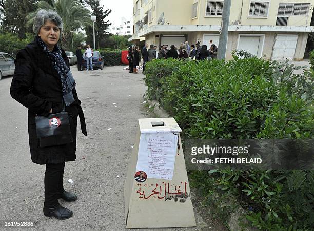 The widow of murdered opposition figure Chokri Belaid, Besma Khalfaoui, stands in front of the vandalised and broken statue erected in his honour, on...