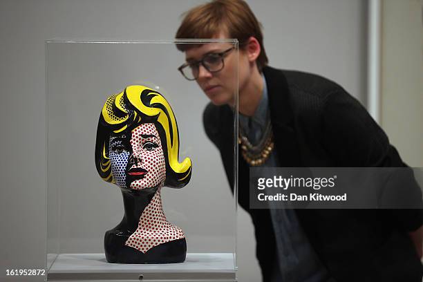 Visitor looks at a Lichtenstein bust during a press preview of 'Lichtenstein, a Retrospective' at the Tate Modern on February 18, 2013 in London,...