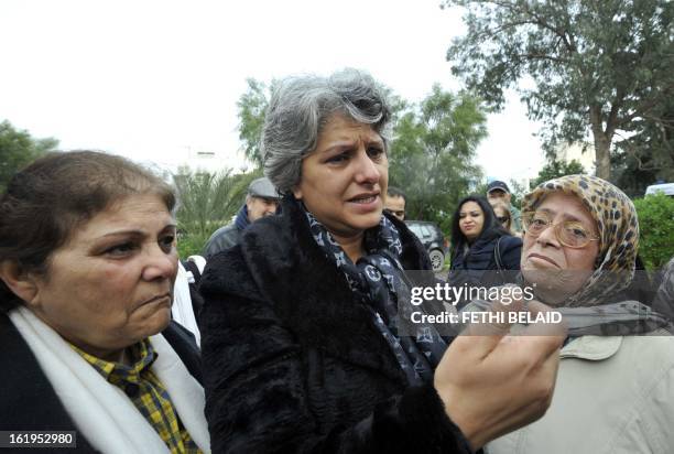 Tunisian journalist and human rigth defender Om Zied stands next to the widow of murdered opposition figure Chokri Belaid, Besma Khalfaoui, as she...