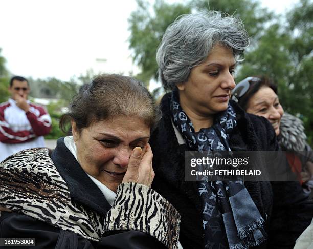 Tunisian journalist and human rigth defender Om Zied weeps as she stands next to the widow of murdered opposition figure Chokri Belaid, Besma...