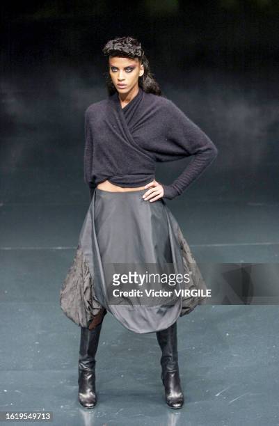 Noémie Lenoir walks the runway during the Alexander McQueen Ready to Wear Spring/Summer 2002 fashion show as part of the Paris Fashion Week on...