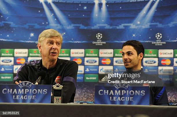 Arsenal manager Arsene Wenger speaks beside Mikel Arteta during a press conference ahead of their UEFA Champions League match against FC Bayern...