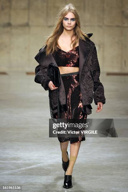 Cara Delevingne walks the runway during the Unique Ready to Wear Fall/Winter 2013-2014 show as part of the London Fashion Week Fall/Winter 2013/14 at...