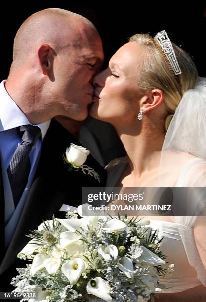 England rugby player Mike Tindall kisses his new bride Britain's Zara Phillips, granddaughter of Queen Elizabeth II, after their wedding ceremony at...