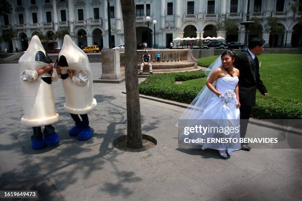 Mimes and actors dressed as condoms participate on November 28, 2008 in an anti-AIDS campaign in Lima, Peru, ahead of International AIDS Day on...