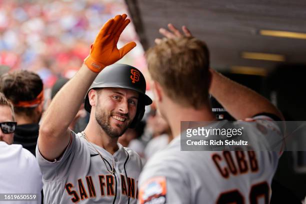 Paul DeJong of the San Francisco Giants is congratulated by pitcher Alex Cobb after hitting a two-run home run during the fourth inning of a game at...