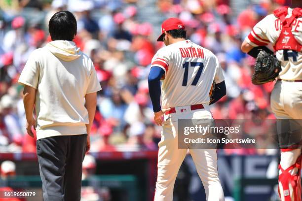 Los Angeles Angels pitcher Shohei Ohtani walks off the mound after being removed from the MLB game 1 of a doubleheader between the Cincinnati Reds...