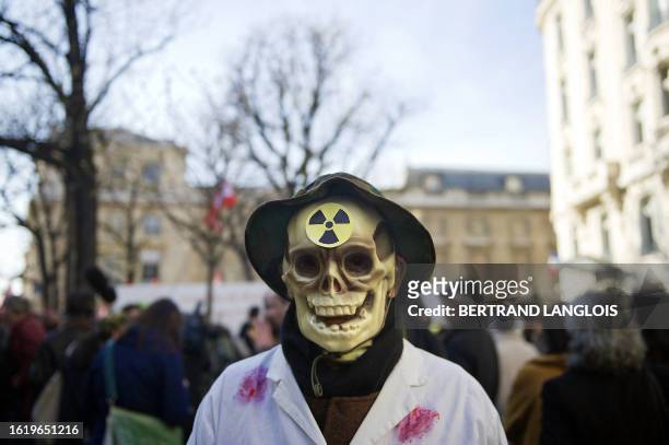 Man wears a skull full face mask during a protest organized by French anti-nuclear network "Sortir du nucleaire" demanding an end to France's nuclear...