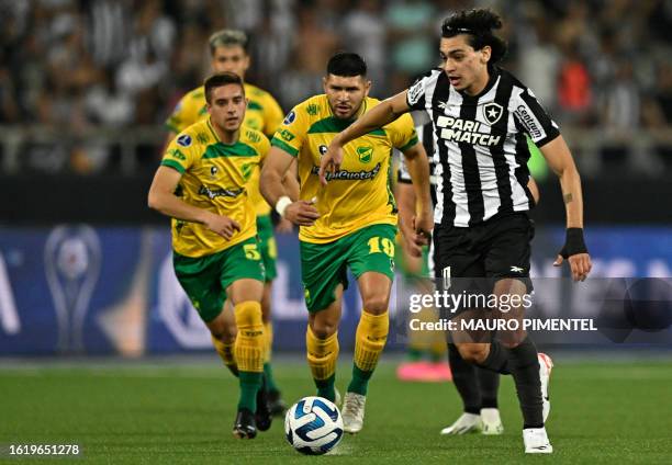 Defensa y Justicia's forward David Barbona and Botafogo's forward Matheus Nascimento fight for the ball during the Copa Sudamericana quarterfinals...