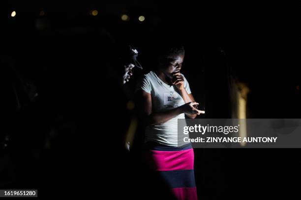 Voters check the names of candidates at a polling station during Zimbabwe's presidential and legislative elections in Bulawayo, on August 23, 2023.