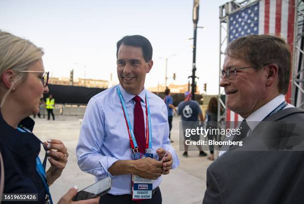 Scott Walker, former governor of Wisconsin, center, speaks with attendees ahead of the Republican primary presidential debate hosted by Fox News in...