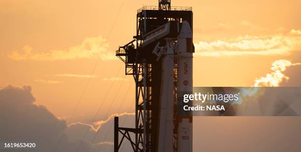 In this NASA handout, a SpaceX Falcon 9 rocket with the company's Dragon spacecraft on top is seen at sunset on the launch pad at Launch Complex 39A...