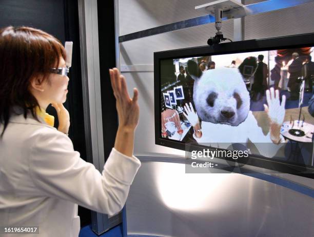 Japan's telecom giant NTT employee demonstrates the new 3D CG morphing system "Dream Boutique" to change her face to animal's head at the NTT group...